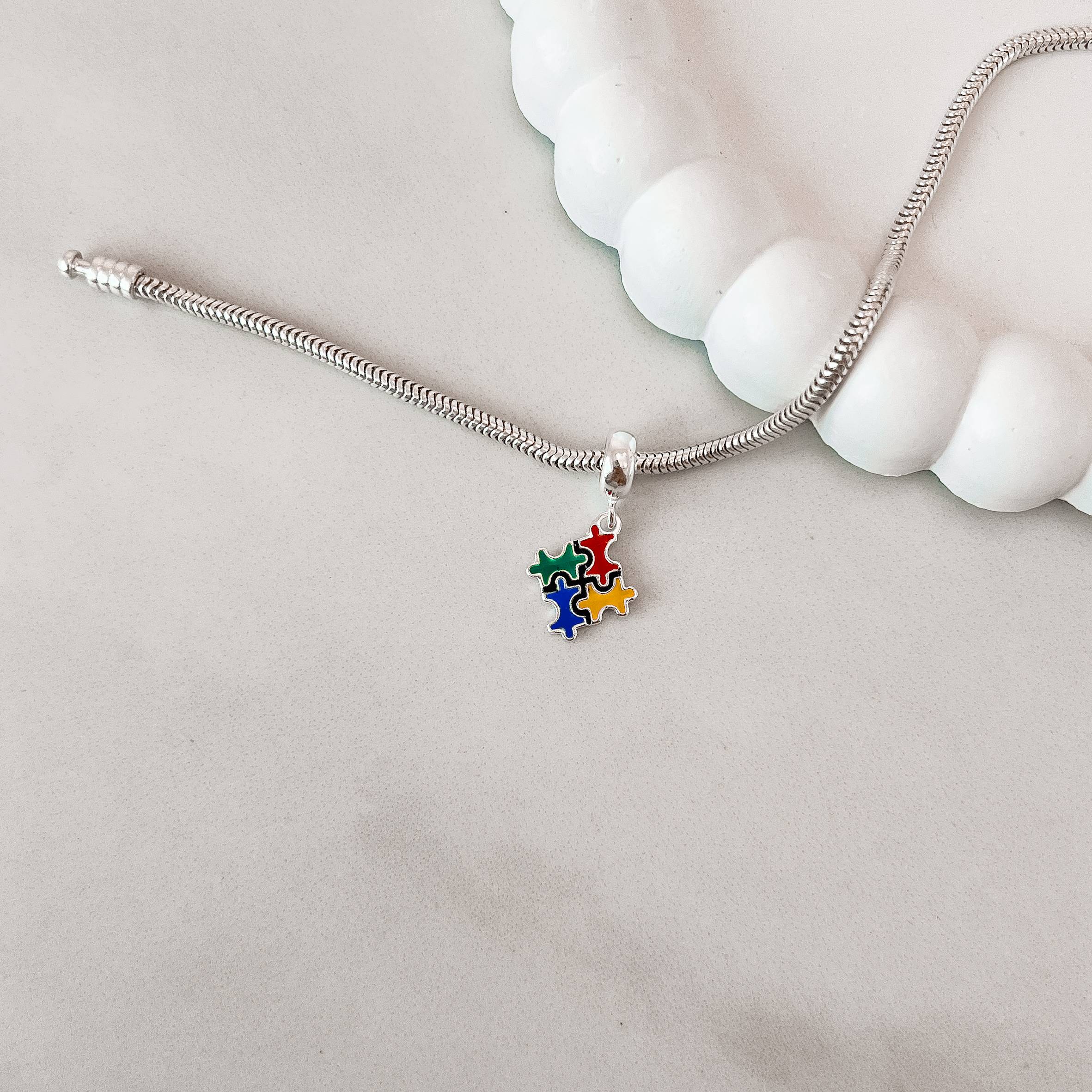 Imagem Secundária Berloque pingente simbolo autismo resina 15mm